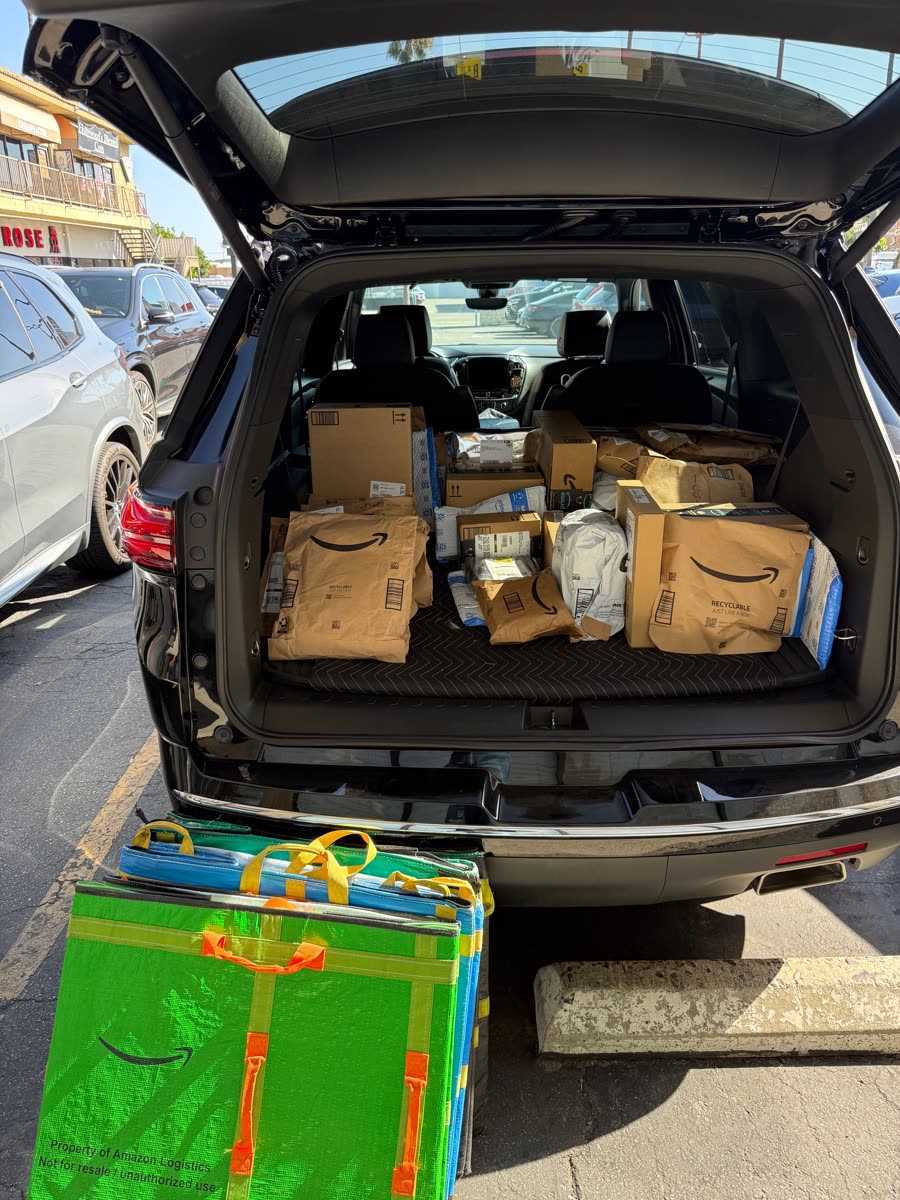Daily Amazon route packages loaded in a black vehicle