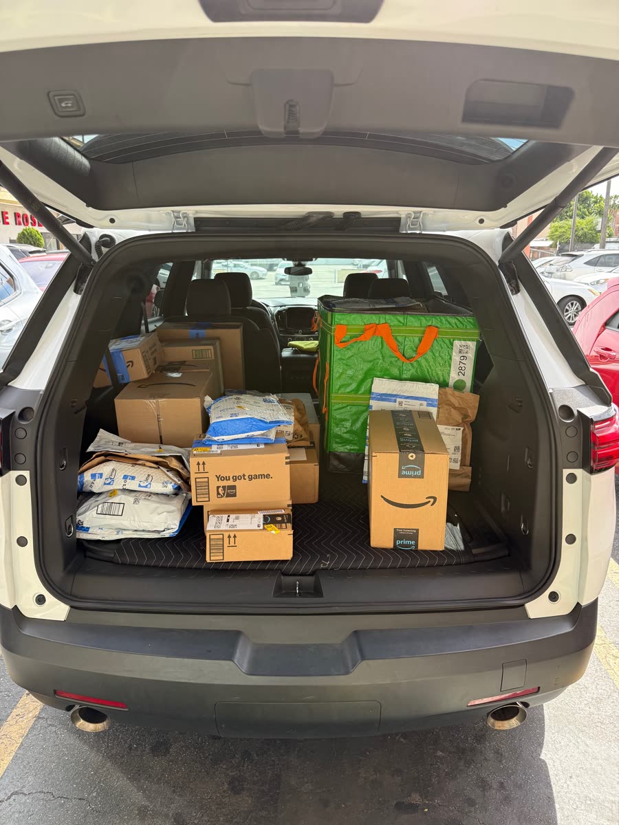 Packages and a delivery container prepared for last-mile service
